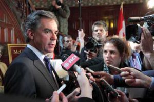 Environment Minister Jim Prentice speaks to reporters following his keynote. / Photo: Owen Egan