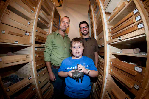 Damien Buckley, centre, holds part of an allosaurus   at the Royal Ontario Museum this past August. Damien spent the day with McGill's Hans Larsson (left) and the ROM's david Evans. / Photo: Wanda Dobrowlanski © Royal Ontario Museum, 2013