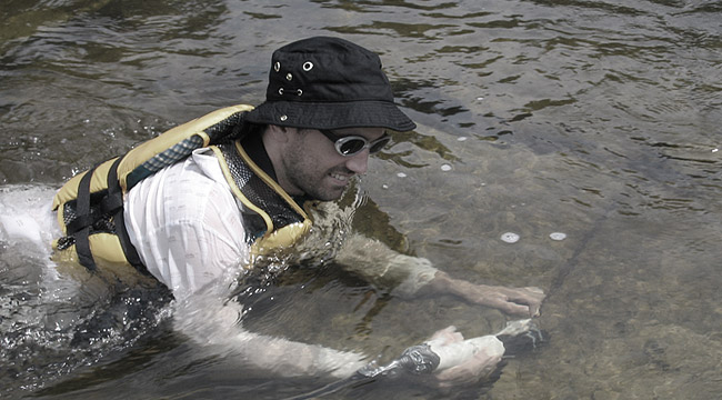 Tom Gleeson in Ontario’s Tay River with a temperature-conductivity probe to detect groundwater coming out of bedrock fractures. / Photo courtesy of Tom Gleeson.