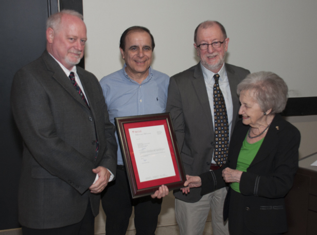 Brenda Milner with a letter from Principal Suzanne Fortier, congratulating her on her 96th birthday. Some 200 people attended Professor Milner's birthday party, including (from left) Neuro director Guy Rouleau and professors Michael Petrides and Gabriel Leonard. (Photo: Helmut Bernhard, Neuro Media Services)