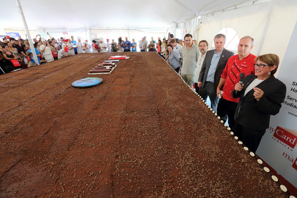 Principal Suzanne Fortier addresses the full house just minutes before she cut the first piece of the two-ton brownie. / Photo: Owen Egan