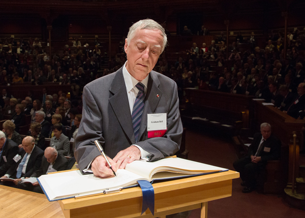Graham A.C. Bell, James McGill Professor of Biology, signs the American Academy of Arts and Sciences’ Book of Members, a tradition that dates back to 1780. / Photo courtesy of the American Academy of Arts and Sciences 