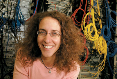 Vicky Kaspi with the Beowulf mini-supercomputer her team  uses to analyze cosmic data