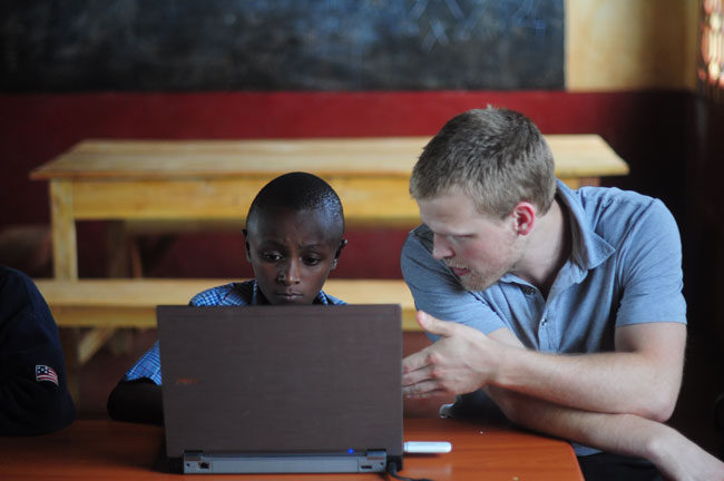 Johnstuart Winchell helps tutor his young charge, Viktor, as part of his internship in Kenya this past summer. / Photo courtesy of Johnstuart Winchell