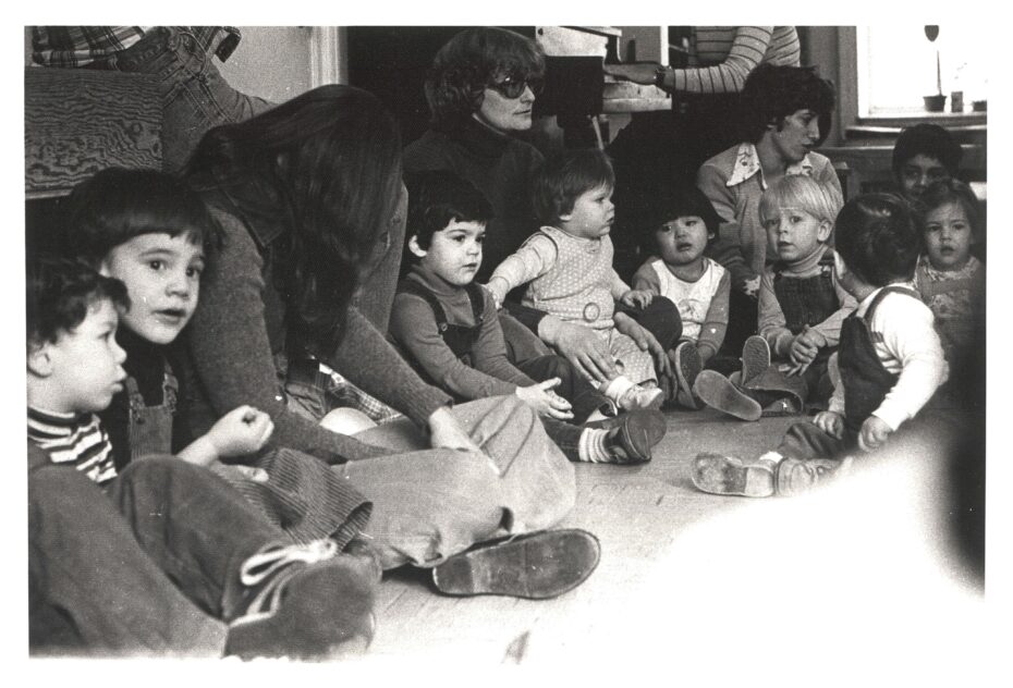 Parents and pre-school aged children seated on the floor 