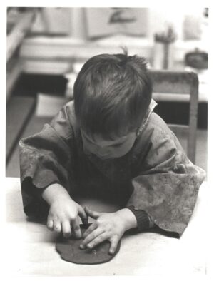 Small child playing with modelling clay