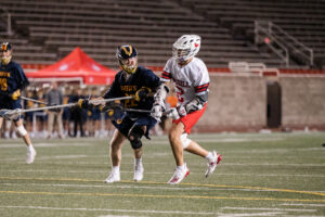 Two lacrosse players in action