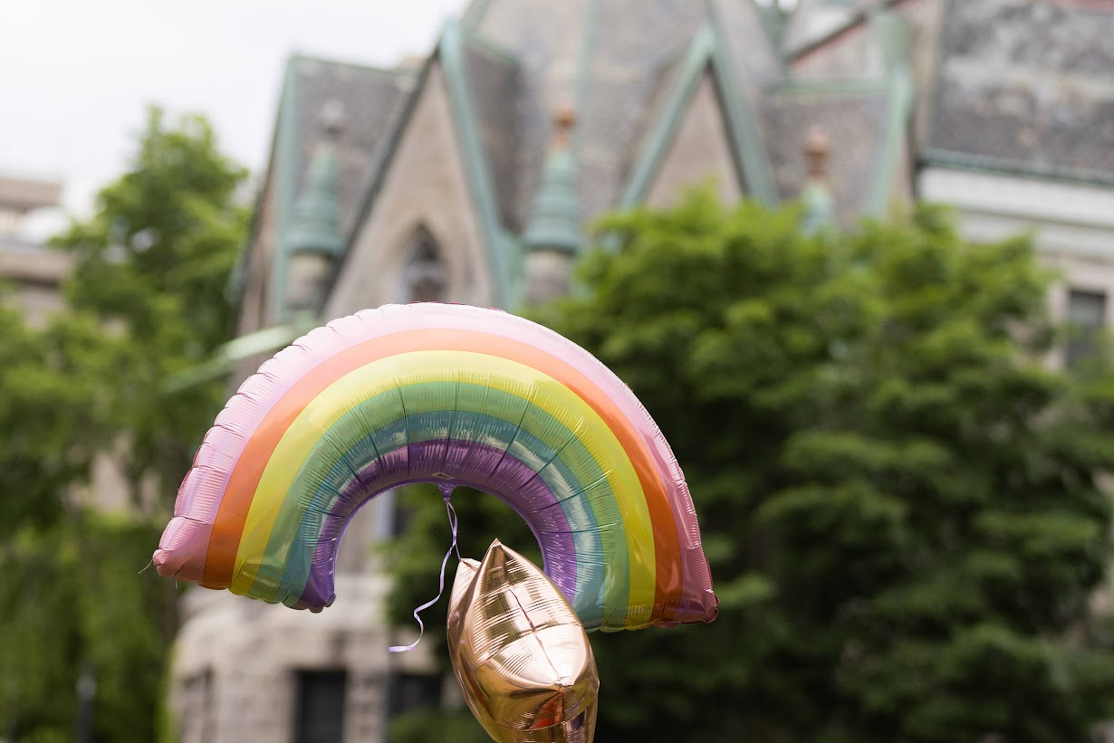 Rainbow-shaped balloon floats in front of McGill campus building