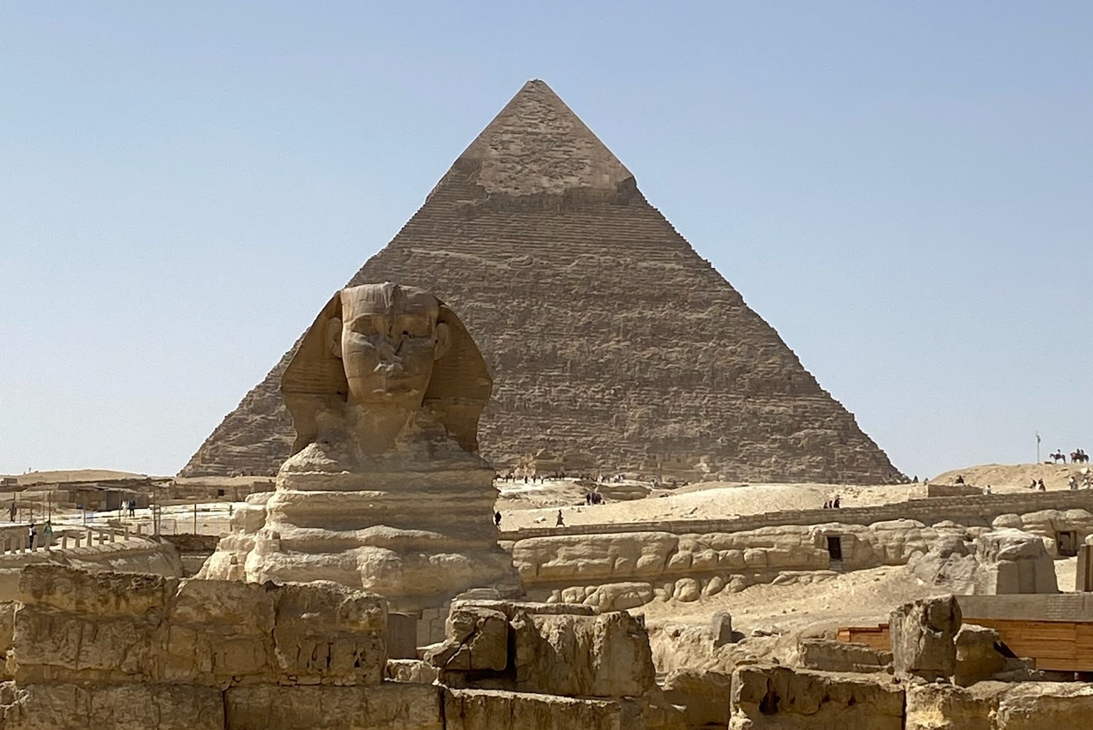 The Great Sphinx in the foreground and the Great Pyramid in the background, located in Egypt