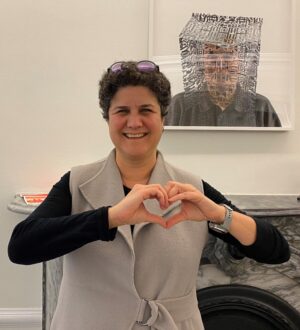 Lisa Shapiro, Dean of the Faculty of Arts, forming the #InspireInclusion heart pose with her hands.