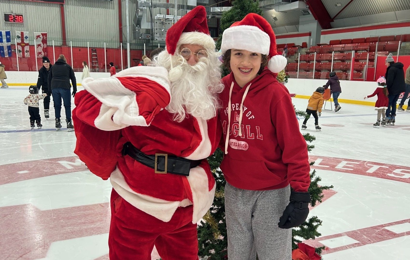 Santa and a child in the McConnell Arena at centre ice