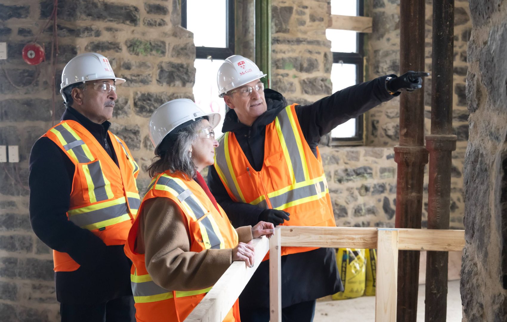 Deep Saini, Julie Dabrusin and Pierre Major in hard hats onsite at the McGill Sustainability Park