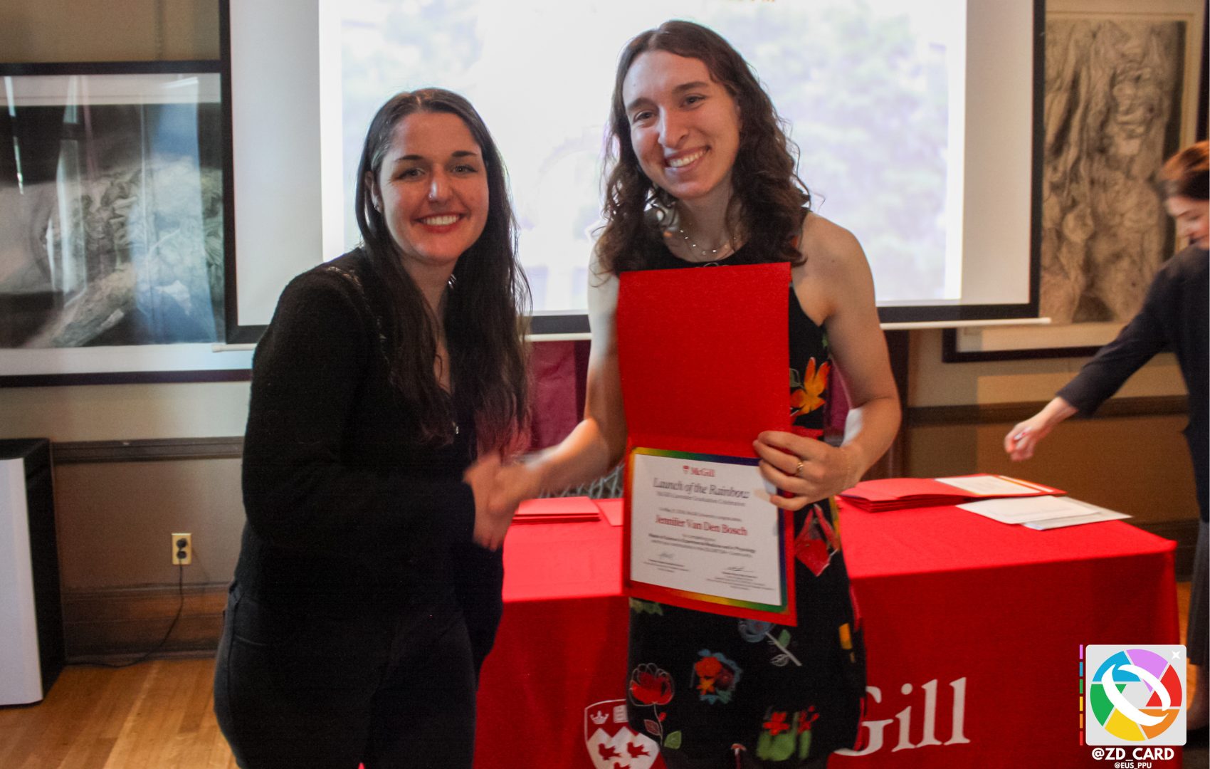 A recipient shaking hands with keynote speaker Prof. Alex Ketchum at Lavender Grad Celebration