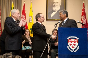 Under the watchful eye of the Founder himself, Macdonald Campus Award of Excellence for Administrative and Support Staff winner Luciano Germani is congratulated by McGill Chancellor Richard Pound (left) and Dean Chandra Madramootoo (right). / Photo: Claudio Calligaris.