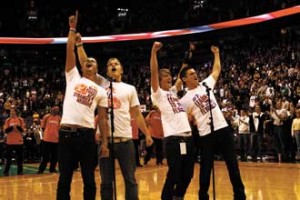 From left to right: Ben Nemtin, Duncan Penn, Jonnie Penn (a McGill History undergrad) and Dave lingwood of the Buried Life project hit the last note of O Canada in front of 20,000 screaming fans prior to an NBA exhibition game. The stunt enabled them to cross #35 off their Things To Do Before We Die list. / Photo: Kyle Jewell