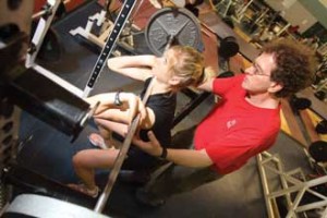 Strength coach Claude Hebert spots Heather McCurdy (4th year Physical Education and Health Education) for a set of front squats. / Photo: Owen Egan