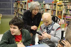 Science Outreach Coordinator Ingrid Birker (centre) shares a sample of volcanic rock with école secondaire Joseph-Charbonneau student Mario “Junior” Lemire (right) during a Hands-on Science program visit to the school for the disabled in northeastern Montreal in December 2008.  / Photo: Owen Egan