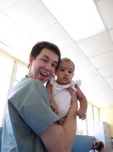     Harald Gjerde holds two-year-old Amanda on the first clinic day.  Diagnosis: the common cold. / Photo: by Hidetaka Ishii